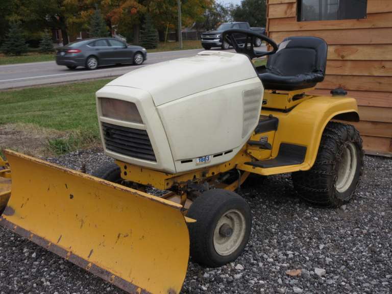 Cub Cadet Heavy Duty Garden Tractor, 1863 Model Incldues 54" Front Blade, Tire Chains, and 54" Mower Deck, Hydro-static Transmission and Blade Lift, Blade Adjusts to Different Angles, 2" Ball Hitch, Adjustable Tilt Steering, Disc Brakes