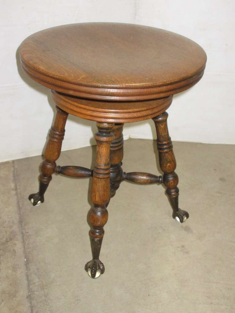 Antique Oak Swivel Piano Stool, Eagle Claw Feet Holding Glass Orbs