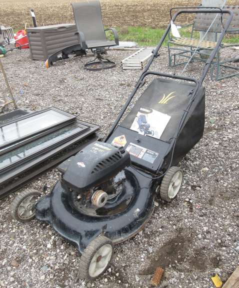 Yardman Push Mower with a 21" Cut and Rear Bagger, 4 HP Briggs & Stratton Engine, Owner's Manual on Tool Bench