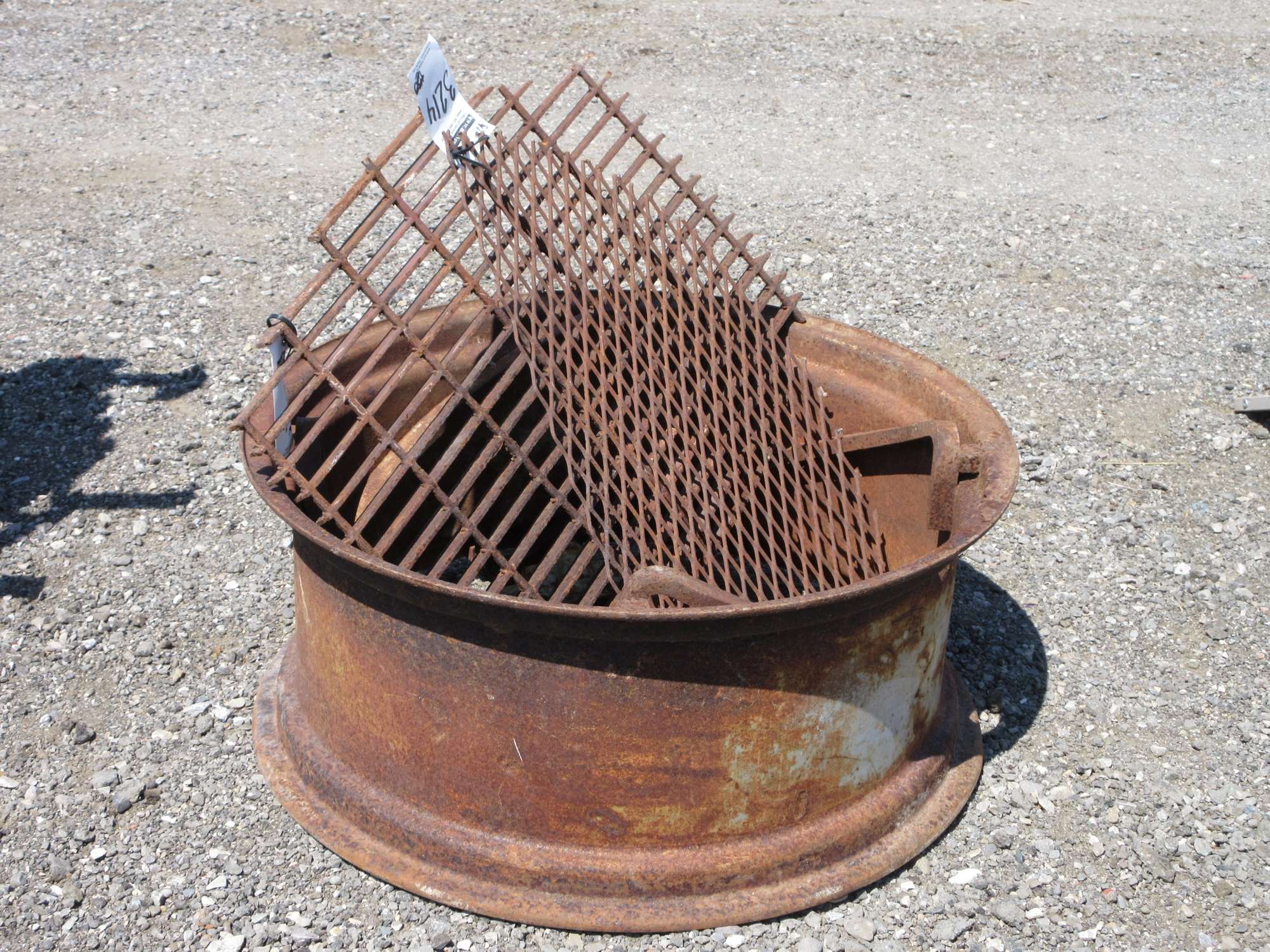 Albrecht Auctions | Fireplace, Large Tire Rim with Grate, and a Smaller ...