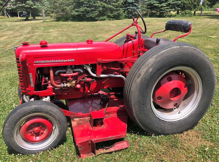 International Cub Lo-Boy with 60" Belly Mower, Turf Tires (Fair Condition), Runs and Mows Well, Extra Belts for Mower, Carburetor Needs Adjustment, Good Condition for Age