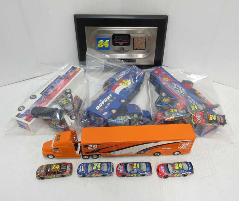 Jeff Gordon Plaque with Indianapolis Speedway Piece of Track, (4) Car Haulers, (16) Hot Wheel Size Cars, and (2) Figures