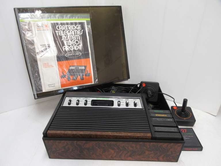 1977 Cartridge Telegames System Video Arcade, Includes Original Owners Manual, (6) Controllers and Telegames, (27) Target Fun Telegames, (3) Blackjack Telegames, (27) Speedway, Game Program Combat, Game Program Haunted House, (50) Telegames, and Super Breakout