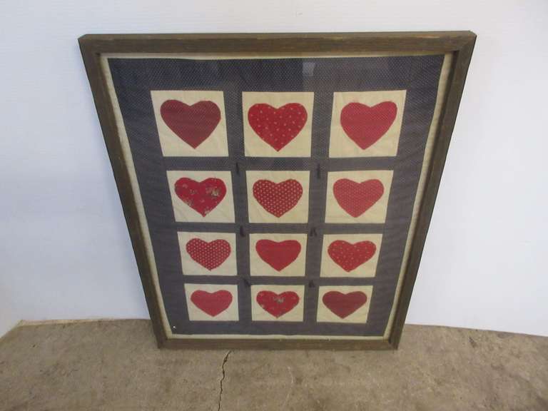 Framed quilt section of hearts, 21"W x 25 1/2"H, needs cleaning, shows wear